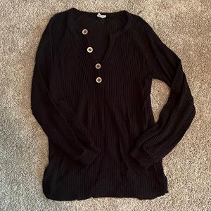 Black sweater with black buttons going down the front. Made by Bibi, size M